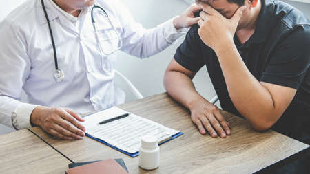 Image of doctor holding patient's hand to encourage, talking with patient cheering and support.の写真素材