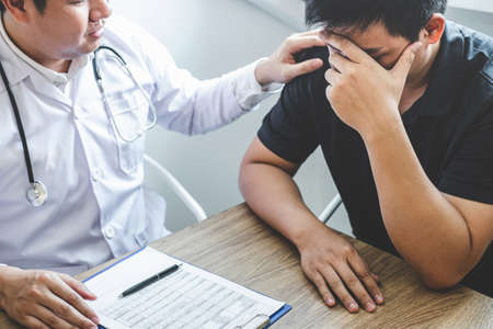 Image of doctor holding patient's hand to encourage, talking with patient cheering and support.の写真素材