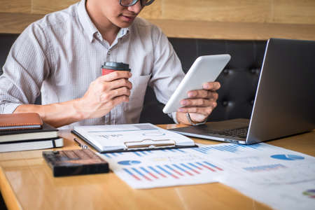 Businessman accountant working audit and calculating expense financial annual financial report balance sheet statement, doing finance making notes on paper checking document.の写真素材