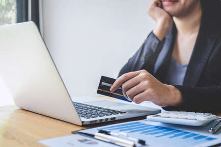 Business woman consumer holding credit card and typing on laptop for online shopping and payment make a purchase on the Internet, Online payment, networking and buy product technology.の写真素材
