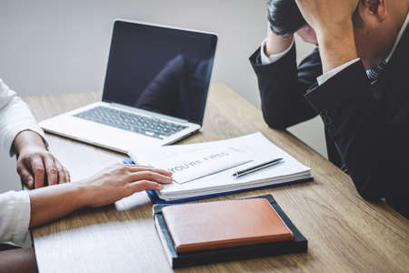 Stressed businessman receive fired letter from employer will be signing approve contract agreement,...