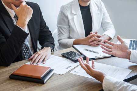 Employer or recruiter holding reading a resume with talking during about his profile of candidate, employer in suit is conducting a job interview, manager resource employment and recruitment concept.の写真素材