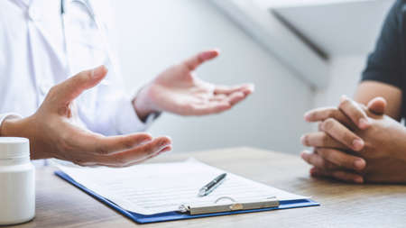 Doctor consulting with patient examining for patient, presenting results symptom about the problem and recommend treatment method, Healthcare and medical concept.の写真素材