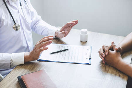 Doctor consulting with patient examining for patient, presenting results symptom about the problem and recommend treatment method, Healthcare and medical concept.の写真素材