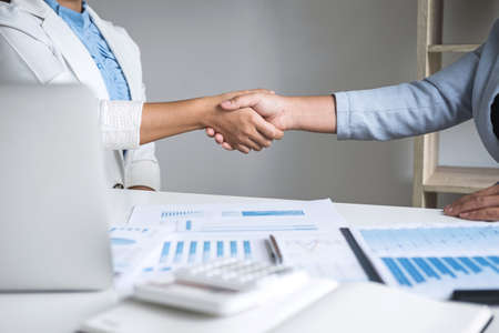 Finishing up a conversation after collaboration, handshake of two business woman leader after successful contract agreement to become a partner, collaborative negotiation partnership.の写真素材