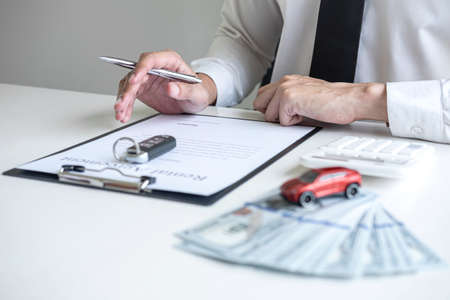 Man client calculating insurance premium for decide signing rental contract form of renting a...