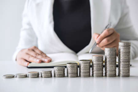 Images of growth stacking coins and Business woman for planning growing business profit step up and savings, Saving money for future plan and retirement fund concept.の写真素材