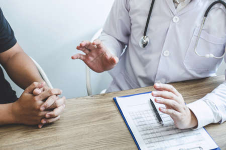 Doctor consulting with patient examining for patient, presenting results symptom about the problem and recommend treatment method, Healthcare and medical concept.の写真素材