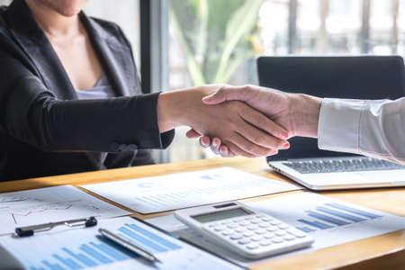 Finishing up a conversation after collaboration, handshake of two business people after contract agreement to become a partner, collaborative teamwork.の写真素材
