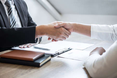 Successful job interview, Image of Boss employer committee or recruiter in suit and new employee shaking hands after good deal negotiation interviewing, career and placement concept.の写真素材