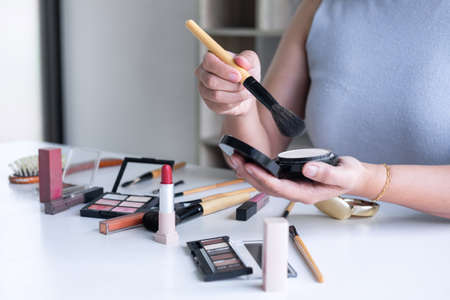 Elegant female Beauty blogger showing testing beauty cosmetic using product makeup tutorial cosmetics and sale product.の写真素材