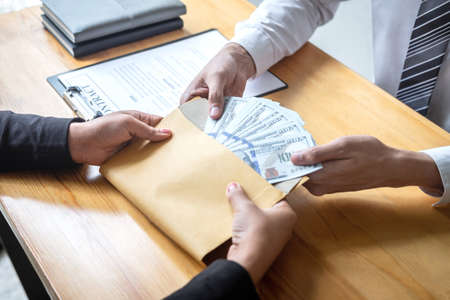 Dishonest cheating in business illegal money, Businessman giving bribe money in envelope to business...
