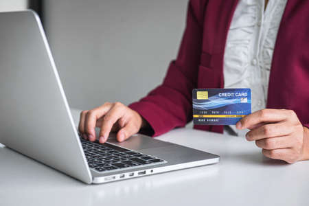 Business woman consumer holding credit card and typing on laptop for online shopping and payment make a purchase on the Internet, Online payment, networking and buy product technology.の写真素材