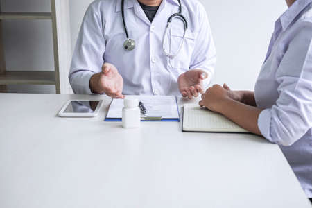 Doctor consulting with patient and checking sickness condition while presenting results diagnosis symptom examining about the problem of illness and recommend treatment method, Healthcare and medical.の写真素材