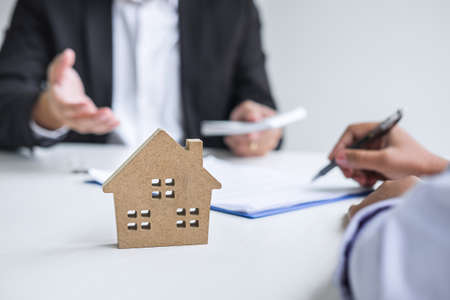Estate agent broker receive money from client after signing agreement contract real estate with approved mortgage application form, buying or concerning mortgage loan offer for and house insurance.の写真素材