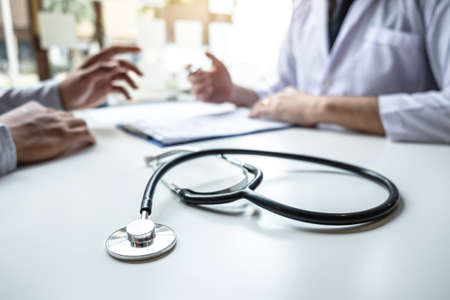 Doctor consulting with patient and checking sickness condition while presenting results diagnosis symptom examining about the problem of illness and recommend treatment method, Healthcare and medical.の写真素材