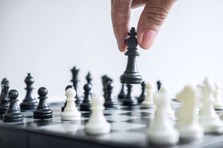 Business woman playing chess and thinking strategy about crash overthrow the opposite team and development analysis for win and successful.の写真素材