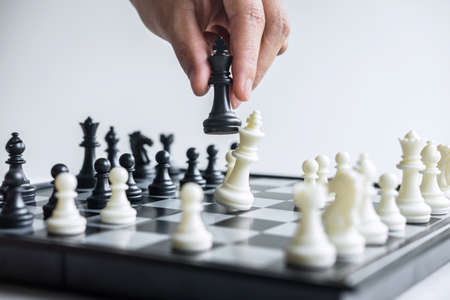 Business woman playing chess and thinking strategy about crash overthrow the opposite team and development analysis for win and successful.の写真素材