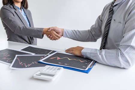 Finishing up a conversation after collaboration, handshake of two business woman leader after successful contract agreement to become a partner, collaborative negotiation partnership.の写真素材