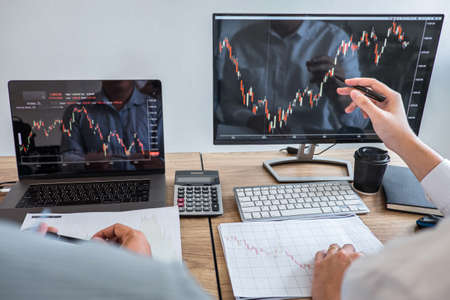 Business team on meeting to planning investment trading project and strategy of deal on a stock exchange with partner, financial and accounting concept, collaborative teamwork analyze data.の写真素材
