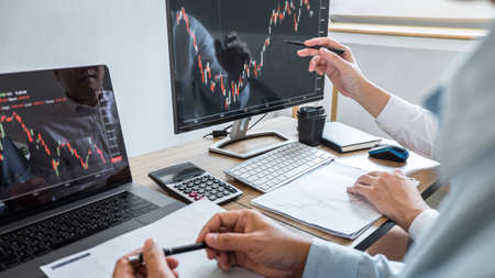 Business team discussion on meeting to planning investment trading project and strategy to investor of deal on a stock exchange with partner, financial and accounting concept, collaborative teamwork.の写真素材