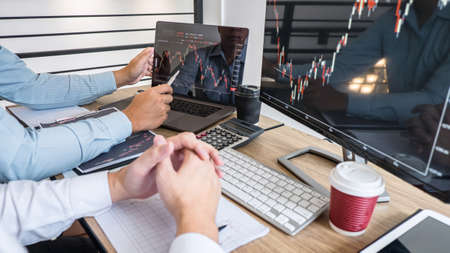 Business team on meeting to planning investment trading project and strategy of deal on a stock exchange with partner, financial and accounting concept, collaborative teamwork analyze data.の写真素材
