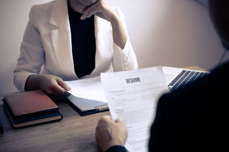 Employer arriving for a job interview, businessman listen to candidate answers explaining about his profile and colloquy dream job, manager sitting in job Interview talking in office.の写真素材