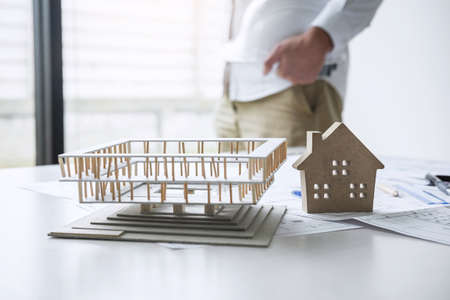 Construction engineering or architect working on blueprint inspection in workplace, while checking information drawing and sketching for architecture project working.の写真素材