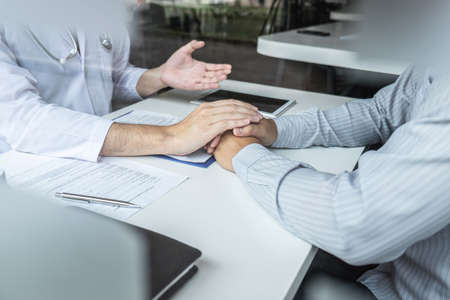 Image of doctor holding patient's hand to encourage, talking with patient cheering and support, healthcare and medical assistant.の写真素材