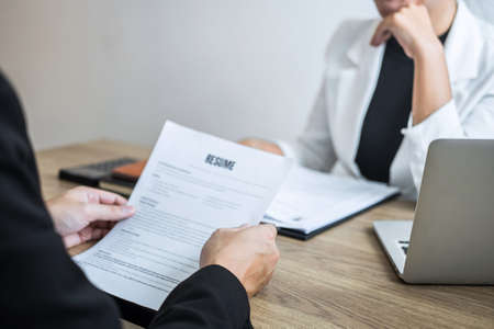 Employer arriving for a job interview, businessman listen to candidate answers explaining about his profile and colloquy dream job, manager sitting in job Interview talking in office.の写真素材