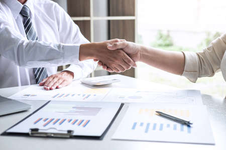 Finishing up a conversation after collaboration, handshake of two business people after success good deal contract negotiation agreement to become a partner, collaborative teamwork.の写真素材