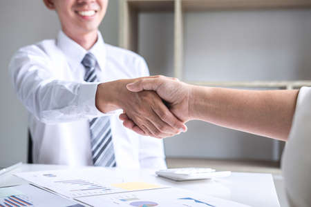 Finishing up a conversation after collaboration, handshake of two business people after success good deal contract negotiation agreement to become a partner, collaborative teamwork.の写真素材