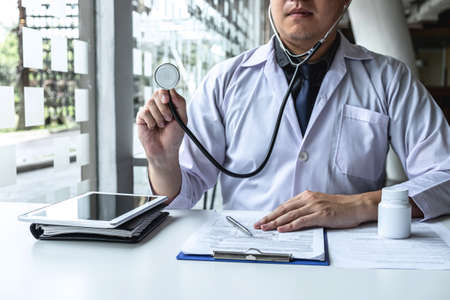 Doctor having conversation with patient while discussing explaining symptoms or counsel diagnosis health and consult treatment of disease, healthcare and assistance concept.の写真素材