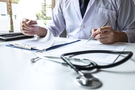 Doctor having conversation with patient while discussing explaining symptoms or counsel diagnosis health and consult treatment of disease, healthcare and assistance concept.の写真素材