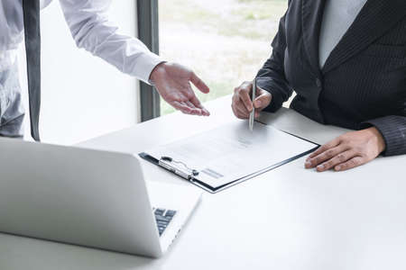 Employer or committee holding reading a resume with talking during about his profile of candidate, employer in suit is conducting a job interview, manager resource employment and recruitment concept.の写真素材