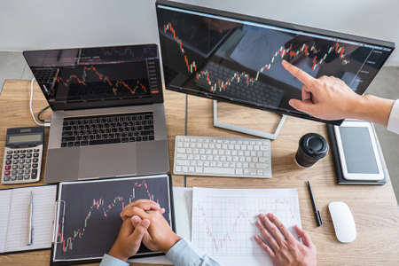 Business team on meeting to planning investment trading project and strategy of deal on a stock exchange with partner, financial and accounting concept, collaborative teamwork analyze data.の写真素材
