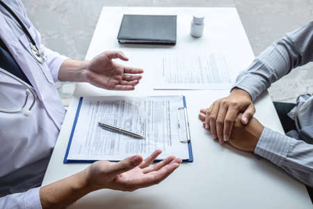 Doctor consulting with patient and checking sickness condition while presenting results diagnosis symptom examining about the problem of illness and recommend treatment method, Healthcare and medical.の写真素材