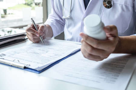Doctor having conversation with patient while discussing explaining symptoms or counsel diagnosis health and consult treatment of disease, healthcare and assistance concept.の写真素材