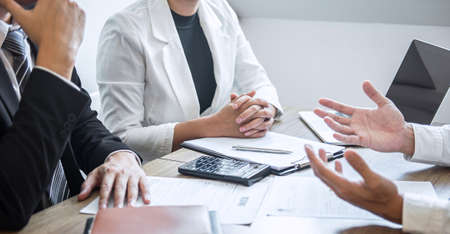 Employer or recruiter holding reading a resume with talking during about his profile of candidate, employer in suit is conducting a job interview, manager resource employment and recruitment concept.の写真素材