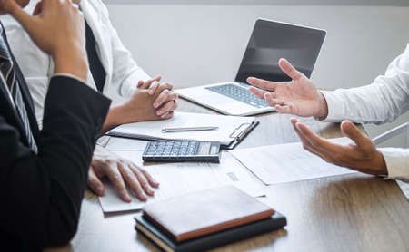 Employer or recruiter holding reading a resume with talking during about his profile of candidate, employer in suit is conducting a job interview, manager resource employment and recruitment concept.の写真素材