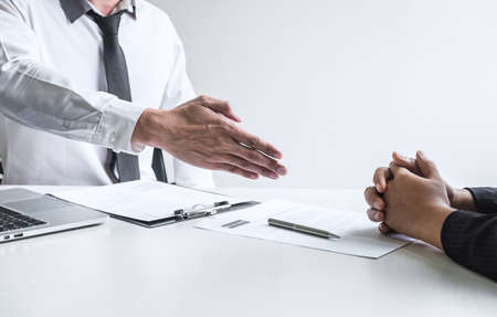 Successful job interview, Boss employer in suit and new employee shaking hands after negotiation and interview, career and placement concept.の写真素材