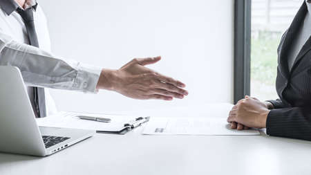 Successful job interview, Boss employer in suit and new employee shaking hands after negotiation and interview, career and placement concept.の写真素材