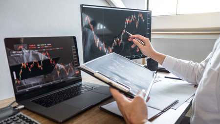 Business investor trading having a planning and analyzing with display screen and pointing on the dataの写真素材