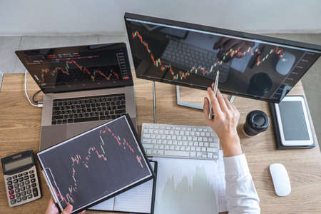 Business investor trading having a planning and analyzing with display screen and pointing on the dataの写真素材