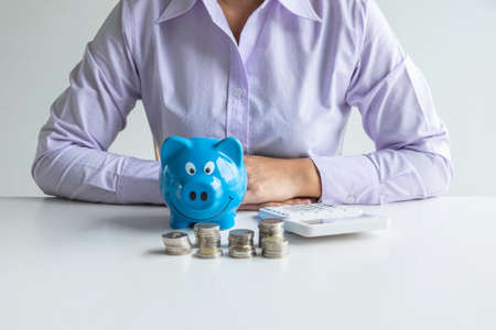 Woman with piggy bankの写真素材