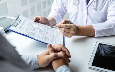 Doctor consulting with patient and checking sickness condition while presenting results diagnosis symptom examining about the problem of illness and recommend treatment method, Healthcare and medical.の写真素材