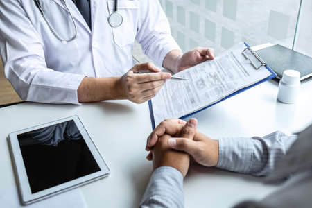 Doctor consulting with patient and checking sickness condition while presenting results diagnosis symptom examining about the problem of illness and recommend treatment method, Healthcare and medical.の写真素材