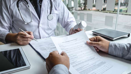Doctor consulting with patient and checking sickness condition while presenting results diagnosis symptom examining about the problem of illness and recommend treatment method, Healthcare and medical.の写真素材