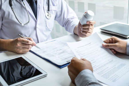 Doctor consulting with patient and checking sickness condition while presenting results diagnosis symptom examining about the problem of illness and recommend treatment method, Healthcare and medical.の写真素材