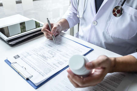 Doctor having conversation with patient while discussing explaining symptoms or counsel diagnosis health and consult treatment of disease, healthcare and assistance concept.の写真素材